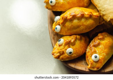 Mini pasties with decorating eyes, succulent pork, turkey, bacon and cranberry all wrapped in shortcrust pastry, funny food - Shutterstock ID 2041893572