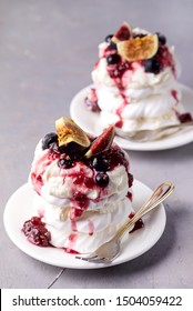 Mini Pavlova Cake with Figs and Berry Tasty Dessert Pavlova on White Plate Gray Background Vertical Meringue