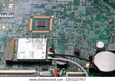 Mini pci wireless network adapter or wireless Mini PCI Express Card on computer circuit board near installed microprocessor.