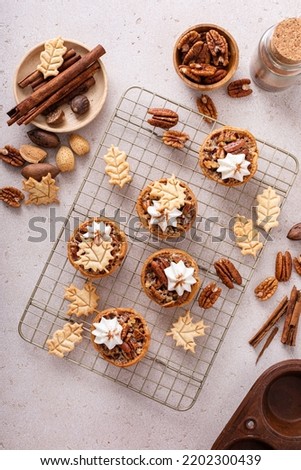 Mini pecan pies baked in a muffin tin, traditional fall or Thanksgiving dessert
