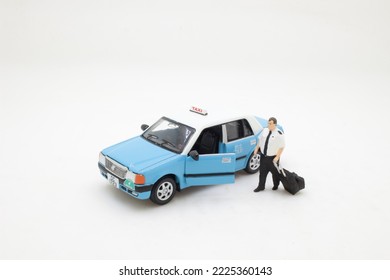 a mini pilot figure by the taxi - Shutterstock ID 2225360143