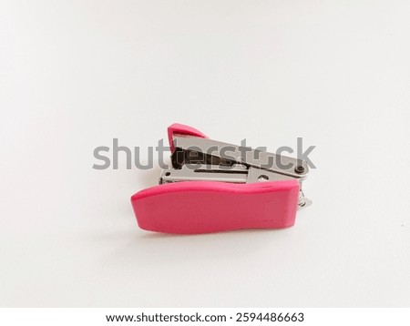 Mini pink stepler isolated on white background. Steples. 