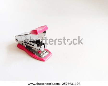 Mini pink stepler isolated on white background. 