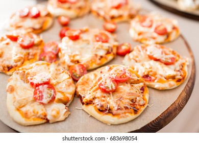 A Lot Of Mini Pizza, On Wood Plate. Catering Buffet. Soft Focus