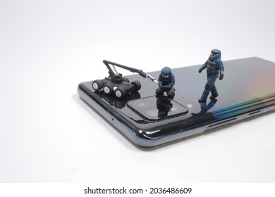 Mini Police Swat Team Officers Using A Mechanical Robot Unit On  Mobile Phone