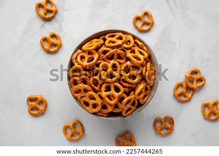 Mini Pretzels with Salt in a Bowl on a gray background, top view. Flat lay, overhead, from above.