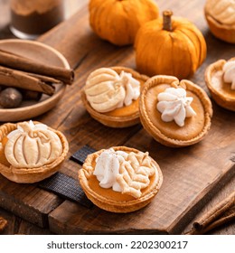 Mini Pumpkin Pies With Wipped Cream And Spices Baked In A Muffin Tin