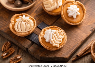 Mini Pumpkin Pies With Wipped Cream And Spices Baked In A Muffin Tin