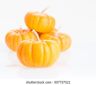 Mini pumpkins close up over white background