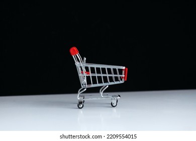 Mini red shopping cart shop concept. Empty top view mini shopping cart or trolley shopping on black background, concept shopping in supermarket.