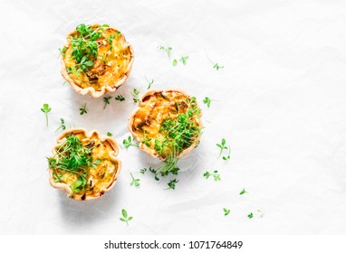 Mini savory pie with chicken, leek, cheese on light background, top view. Delicious appetizer, snack, breakfast, tapas - Shutterstock ID 1071764849