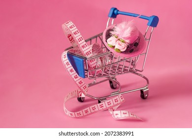 Mini Shopping Cart Measuring Tape and Beautiful Pink Feather Hat, Headwear Making, Custom Tailoring and Sale - Powered by Shutterstock