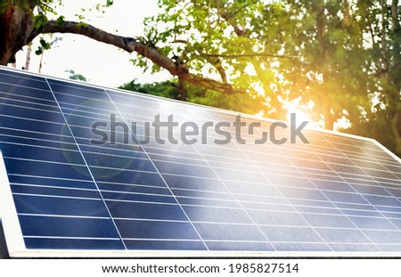 Mini solarcell panel installed under the tree to store and use the power from the sunlight with street lamps around the public park at night.