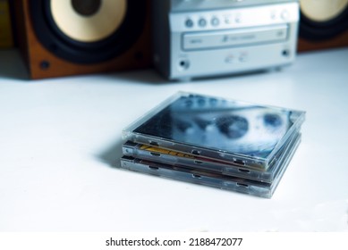 Mini Stereo System From The 90s And Old Cds On White Shelf