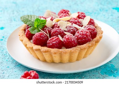 Mini Tartlet With Vanilla Custard, Raspberry, Almond Flakes And Green Mint, Selective Focus. Homemade Shortcrust Pastry. 