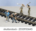 Mini toy of action figure at outdoor with blurred background. Toy photography concept design. Minifigure of train worker character at railtrack.