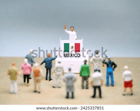 Mini toy of action figure at table with blurred background. General election concept design.