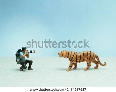 Mini toy of action figure at table with blurred background. Toy photography concept design. Animal wildlife photographer concept.