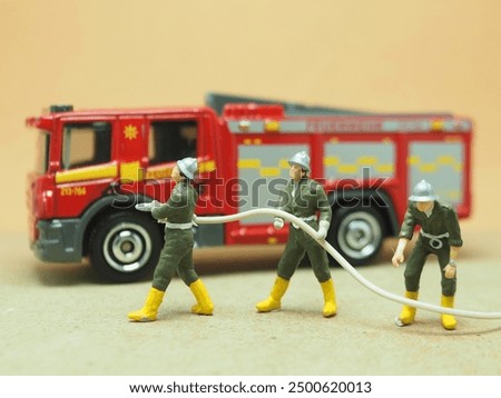 Mini toy of action figure at table with blurred background. Toy photography concept design. Firefighter crew concept.
