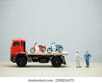Mini toy at table with blurred background. Towing truck concept design.