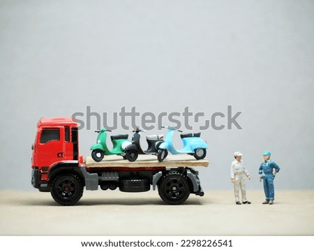 Mini toy at table with blurred background. Towing truck concept design.