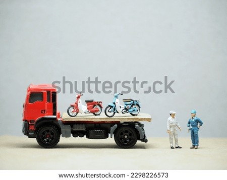 Mini toy at table with blurred background. Towing truck concept design.