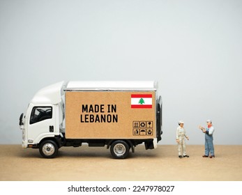 Mini toy at table with white background. International Shipping design. Made in Lebanon concept.