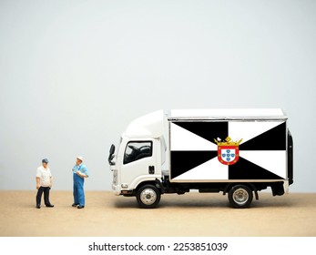 Mini toy at table with white background. Industrial shipping concept. Ceuta flag design, is a Spanish autonomous city on the north coast of Africa. - Shutterstock ID 2253851039