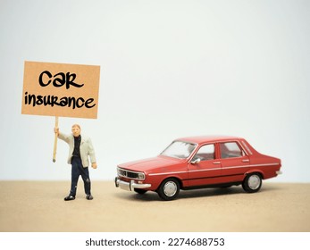 Mini toy at table with white background. Car Insurance concept.