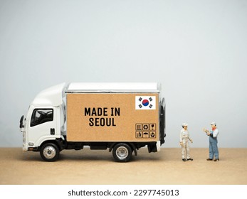 Mini toy at table with white background. Industrial shipping concept. Made in Seoul design.