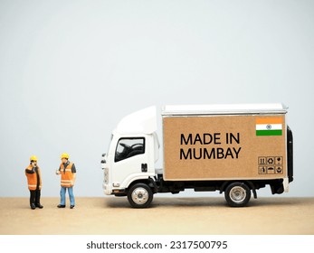 Mini toy at table with white background. Industrial shipping concept. Made in Mumbay design.