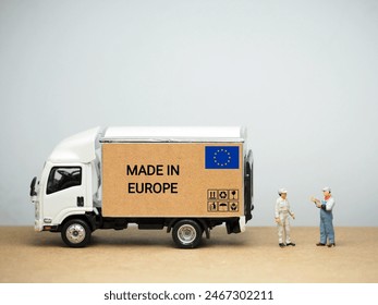 Mini toy at table with white background. Industrial shipping concept. Made in Europe design.