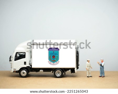Mini toy at table with white background. Industrial shipping concept. Highland Papua (Indonesian: Papua Pegunungan) is a province of Indonesia.