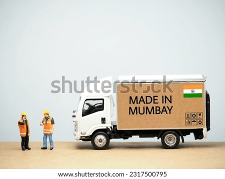 Mini toy at table with white background. Industrial shipping concept. Made in Mumbay design.