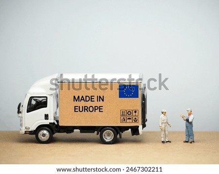 Mini toy at table with white background. Industrial shipping concept. Made in Europe design.