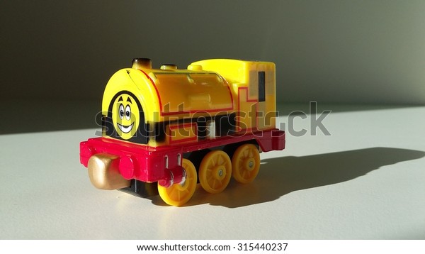 Mini\
train toy. Plastic train model. Photo with\
shades