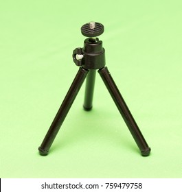 Mini Tripod On A Green Background