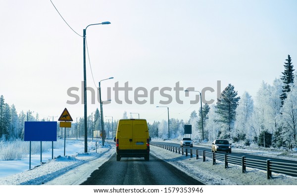 Mini Van on Winter road
with snow in Finland. Car and cold landscape of Lapland. Europe
forest. Finnish City highway ride. Roadway and route snowy street
trip. Driving