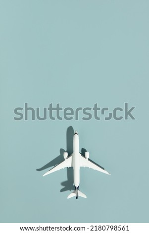 Miniature airplane on blue background with copy space. ravel, vacations, tourism, airlines, low cost flights concept. Top view, flat lay.