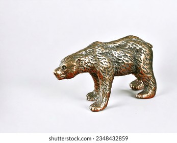Miniature animal bronze bear statue on white background