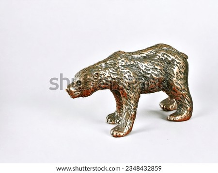 Miniature animal bronze bear statue on white background
