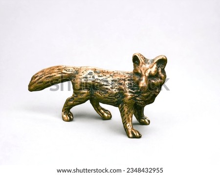 Miniature animal bronze fox statue on white background
