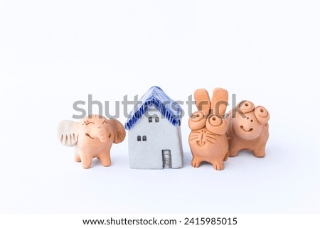 Miniature animal clay doll with vintage style miniature house isolate on white background, garden decoration item, animal home