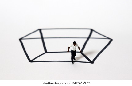 A miniature black man in a rectangle of black solid lines.