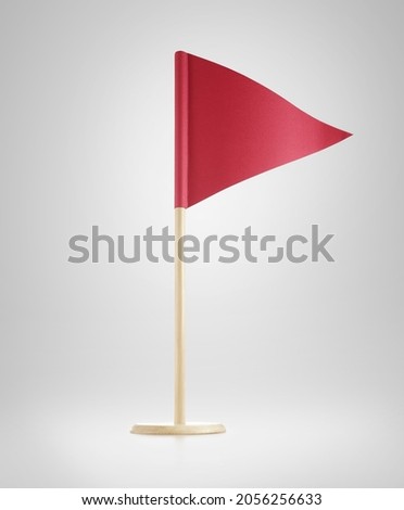 Miniature blank red flag. Ready for a Message. red triangular paper flag. Paper flag Isolated on grey background.