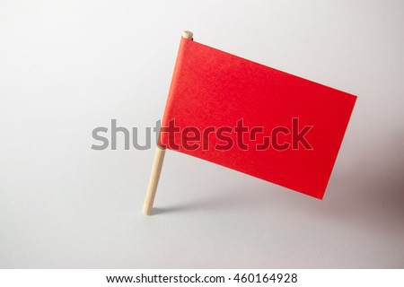 Miniature blank red flag. Ready for a Message. Paper flag Isolated on white background.