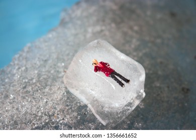 Miniature Business Man Frozen In Time Talking On His Outdated Cell Phone. Ice Man Trapped By Modern Technology. Boss Or Employee Is Left Out In The Cold. Problems Working In Tech. Man Chilling Out.