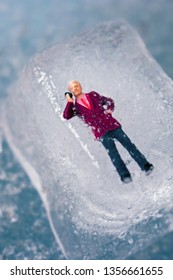 Miniature Business Man Frozen In Time Talking On His Outdated Cell Phone. Ice Man Trapped By Modern Technology. Boss Or Employee Is Left Out In The Cold. Problems Working In Tech. Man Chilling Out.