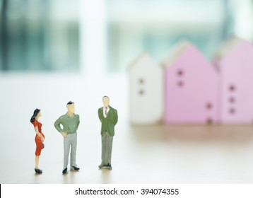 Miniature Business People Negotiating Witth Blur House Mode Background