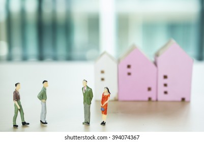 Miniature Business People Negotiating Witth Blur House Mode Background